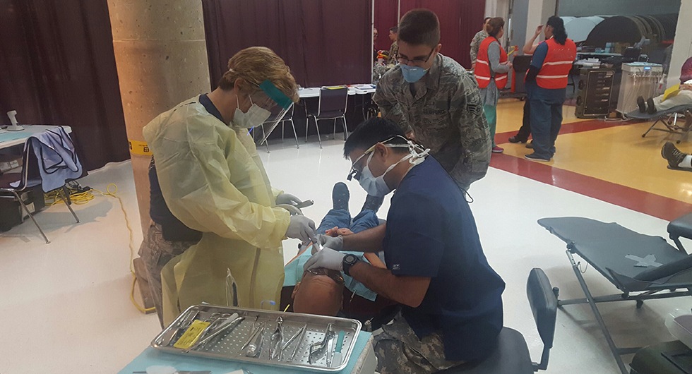 Dentist and team members treating dental patient