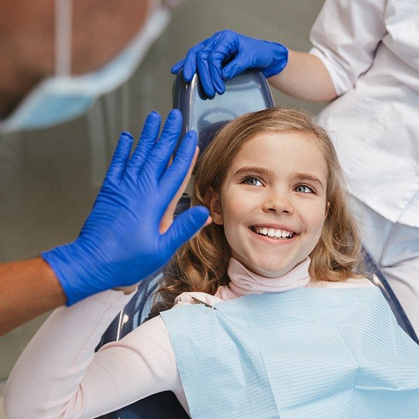 Little girl with dental sealants smiling during children's dentistry visit
